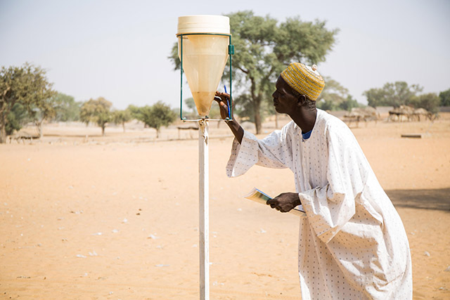 Ali Sabo, 51, monitors rainfall using a rain gauge in Zinder, Niger.